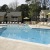 large swimming pool surrounded by lounge chairs