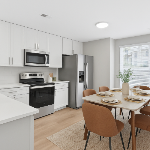 Stainless steel appliances and white cabinetry inside an apartment home at LYV Six Forks